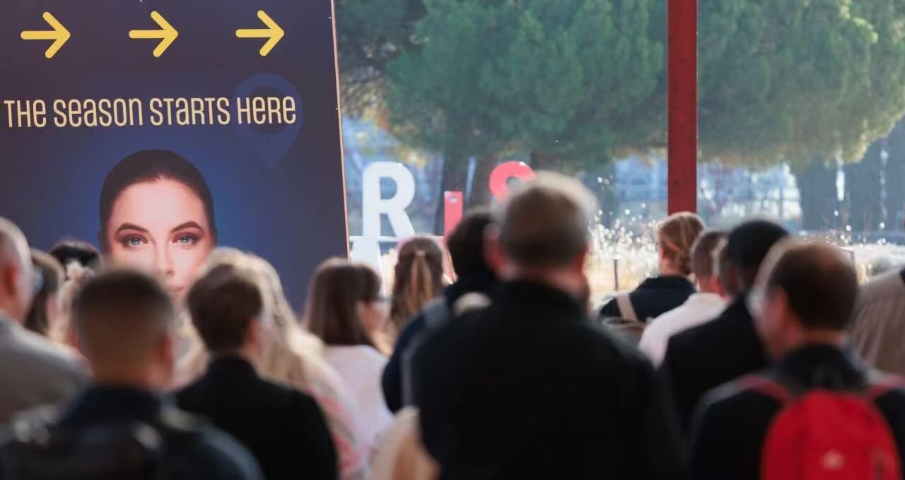 Visitors beside a SILMO Paris promotional display at the entrance